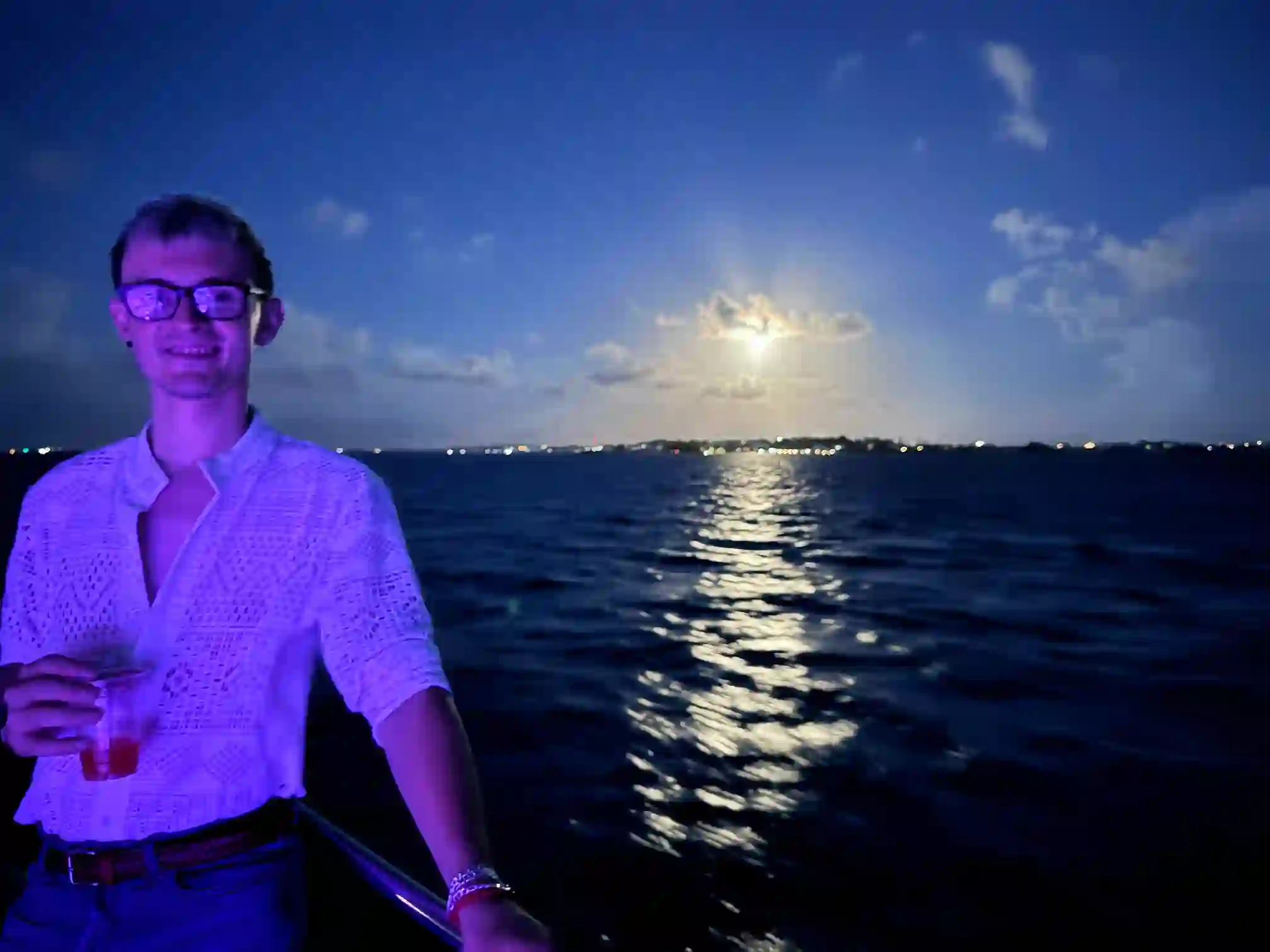 Alex at the White Party sailing excursion in Bermuda stood in the moonlight