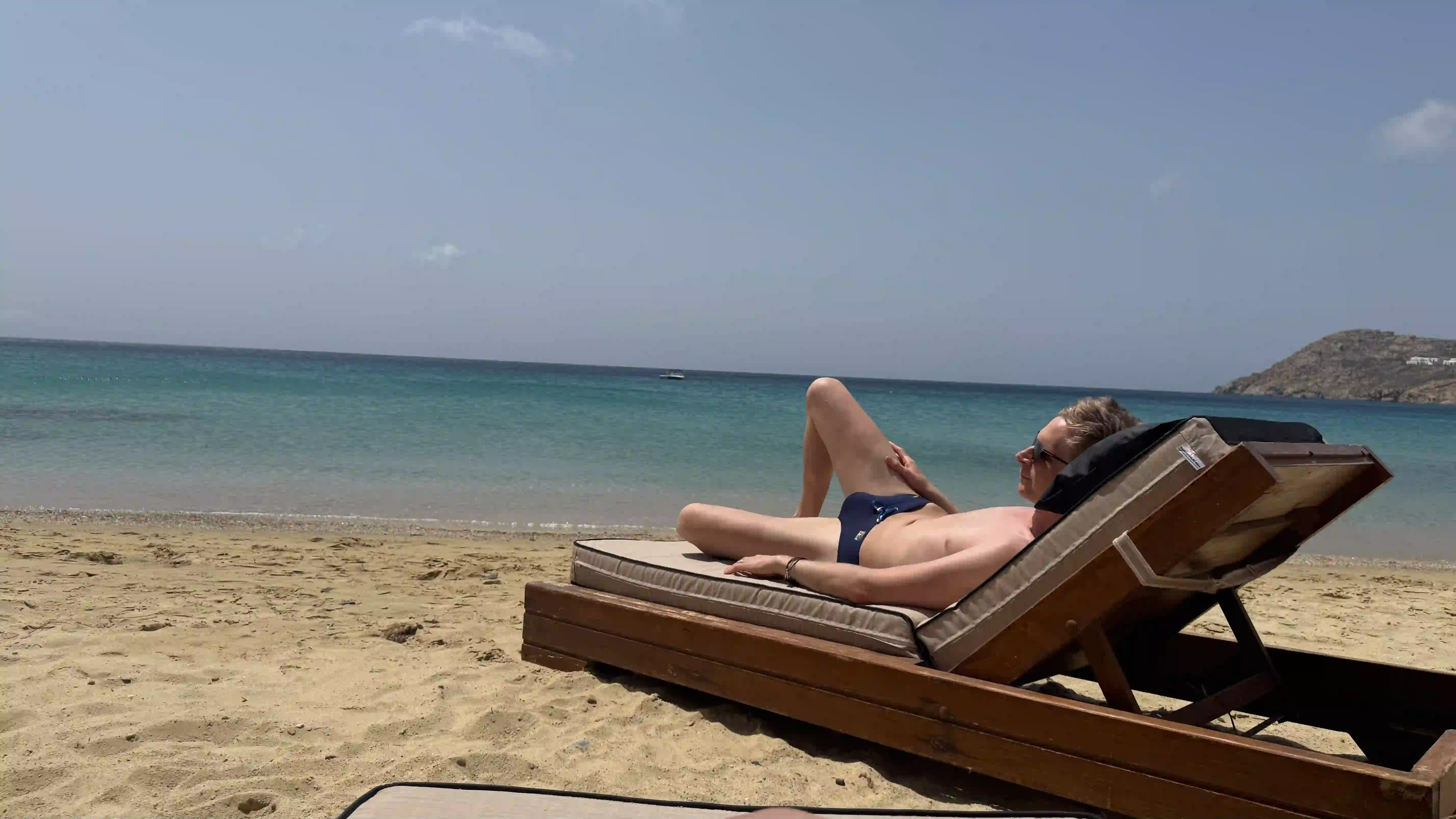 Joe on a beautiful Mykonos beach enjoying the sun